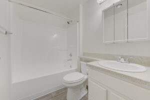 Interior Unit Bathroom, Granite like countertops, white cabinetry, white appliances, medicine cabinet vanity, shower/bathtub.