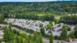 Aerial Exterior of maple crossing and surrounding areas, dense forest behind community.