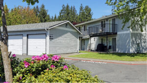 Exterior Maple crossing, Residential Building and garage in photo, meticulous landscaping, lush foliage, photo taken on a sunny day.